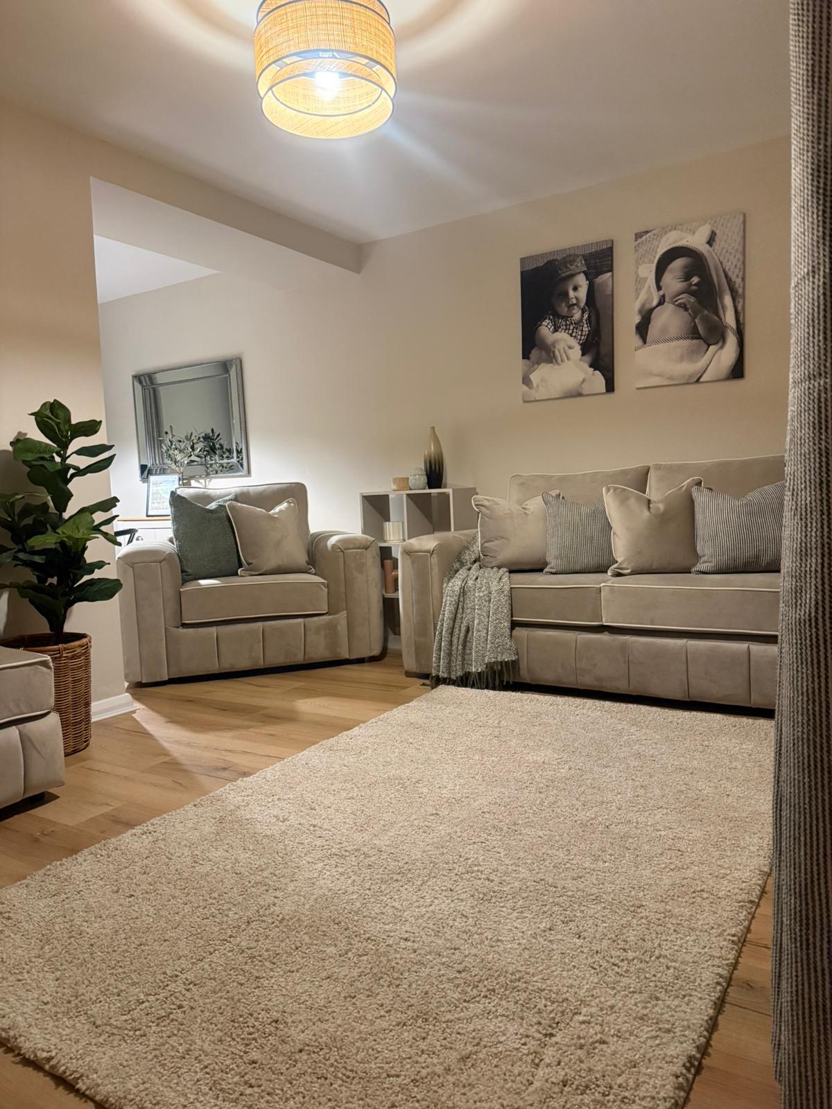 Beth's transformed family living room: cream walls, plush sofas, soft rattan lighting